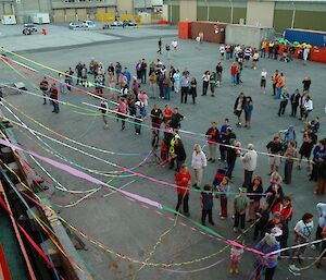 People waving from the wharf as the Aurora prepares to depart