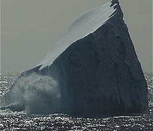 Wave crashing against an iceberg