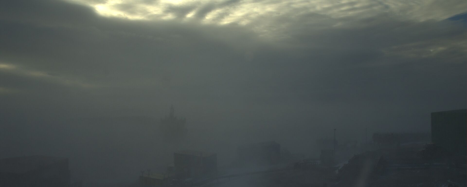 A tiny bit of blue sky shows through an almost totally obscured view from Mawson station