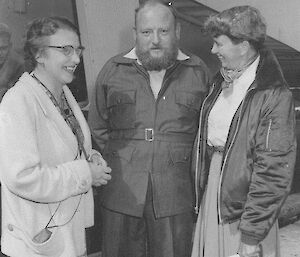 Two female scientists with a male expeditioner on ship’s deck