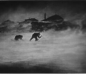 Two figures struggle through a blizzard.