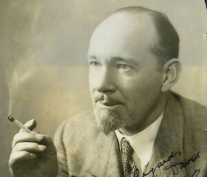 Studio portrait of well dress man holding cigarette