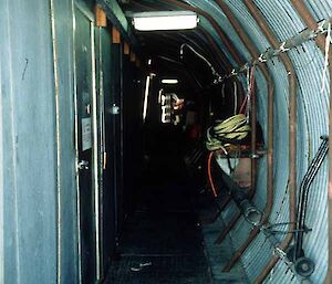 Looking down a corridor with a curved metal wall.