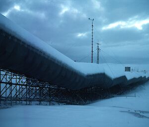 Long corrugated iron cladded station building in stilts above the ground