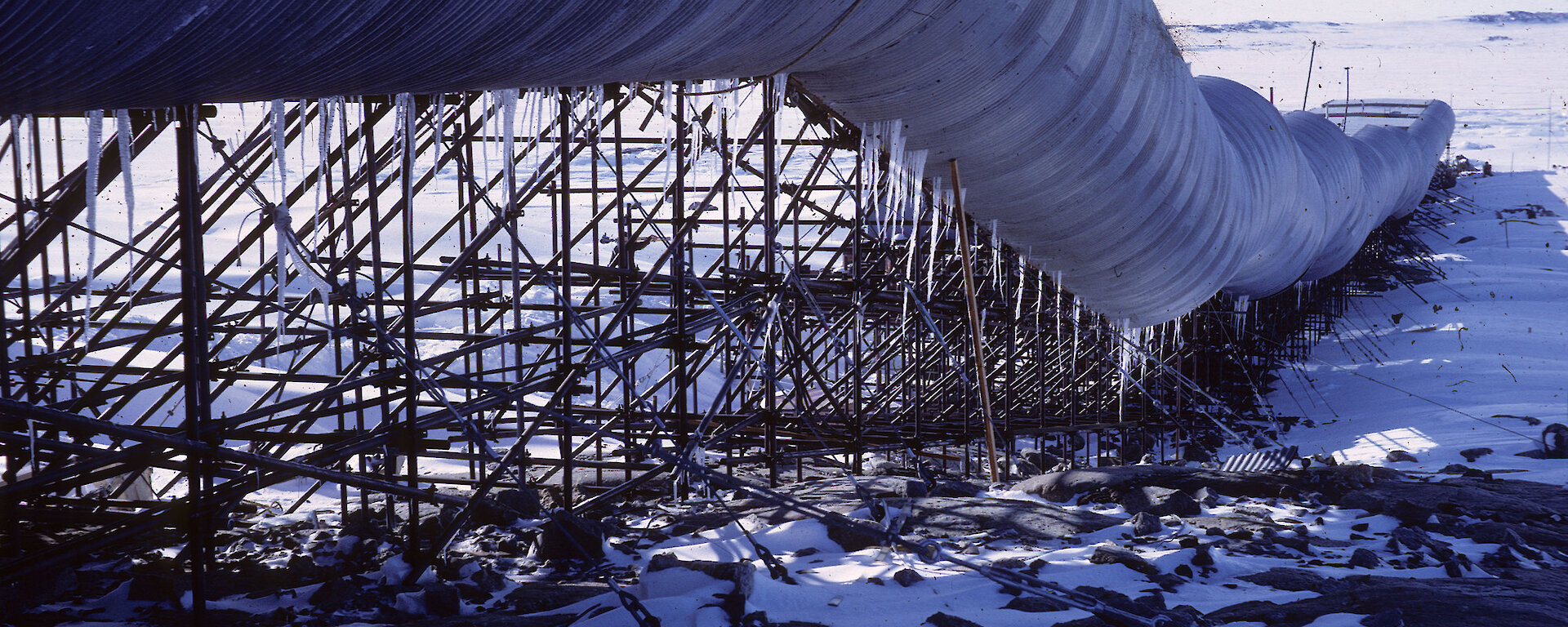 Looking along the curved wall of the Casey tunnel building, looks like a large, long metal pipe