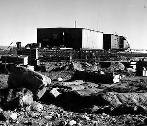 Black and white image of iron cladded station building under construction