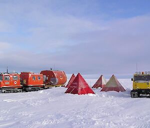 Tents and vehicles in the snow.