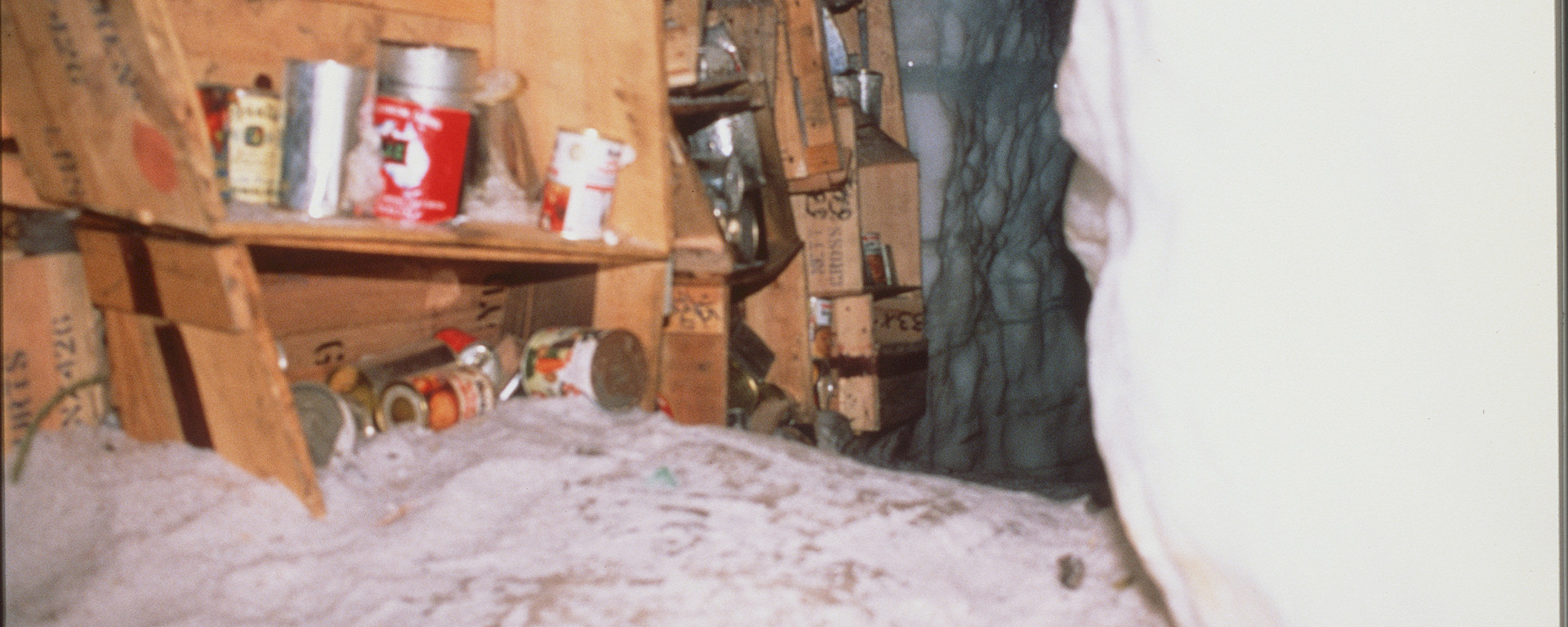 Food on shelves inside iced up campsite.