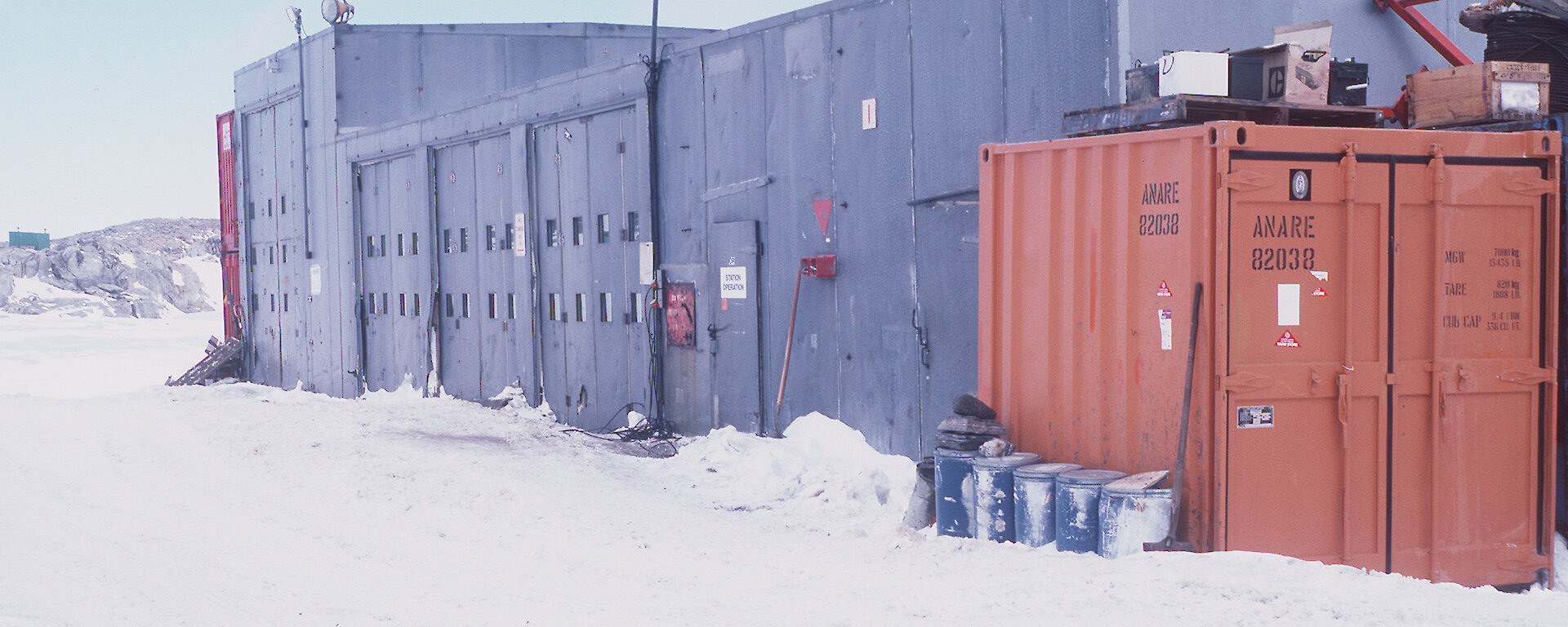 An old photo of a grey building.