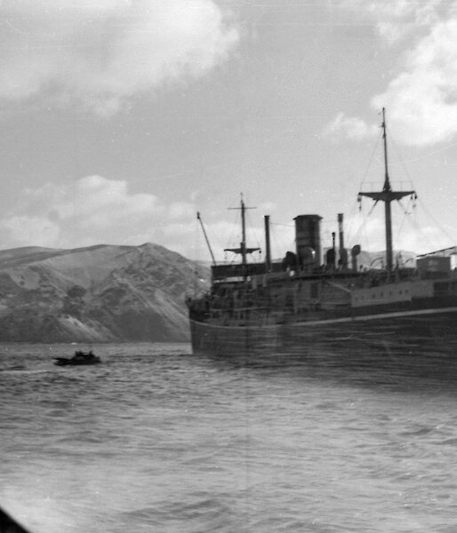 Black and white image of ship at anchor of coast
