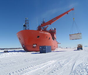 Unloading cargo from the Aurora Australis, on the fast ice at Davis station.