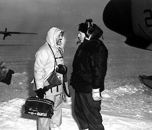 Black and white image of AAD director being welcomed at American ice landing area