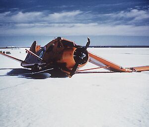 A wrecked plane in the snow.