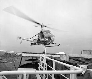 Hiller 12 C helicopter lifting off from helideck of the Magga Dan