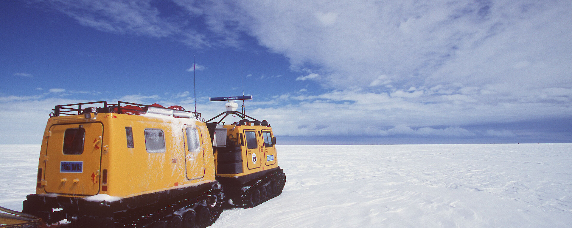 Hägglunds driving across the ice, away from the camera