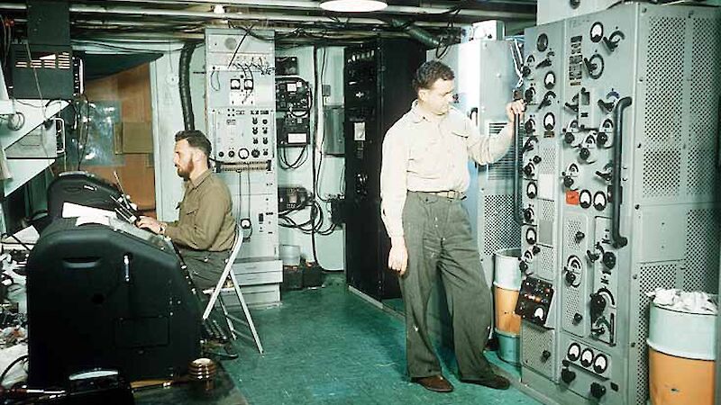 Room full of large computers and radio equipment.