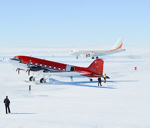 A Basler aircraft in the foreground, with A319 aircraft in the background