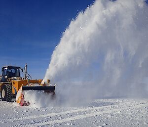 Machinery out on the runway blowing snow off it.