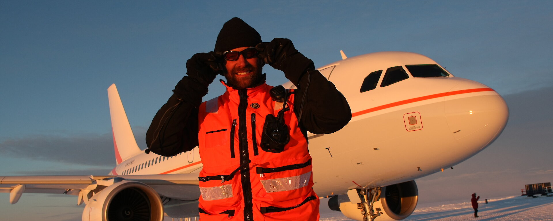 Expeditioner in front of aircraft on the ice