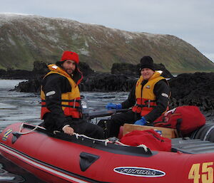 Two people in an IRB floating on the water.