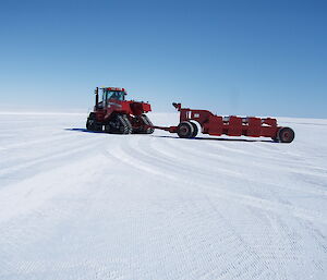 A large proof roller flattens the icy runway