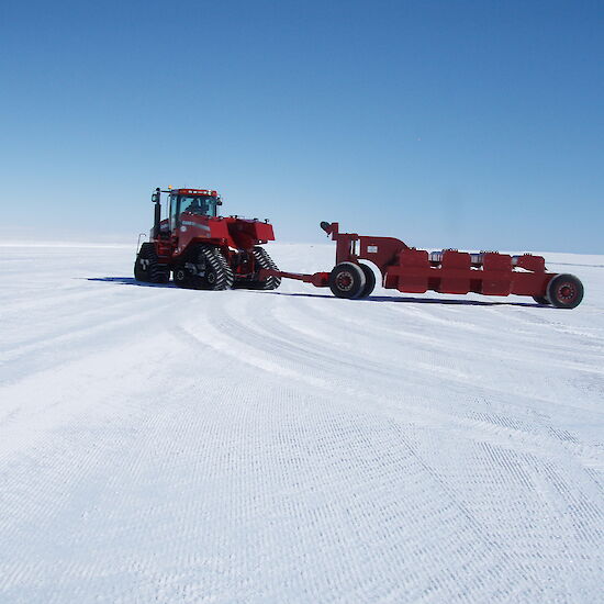 A large proof roller flattens the icy runway
