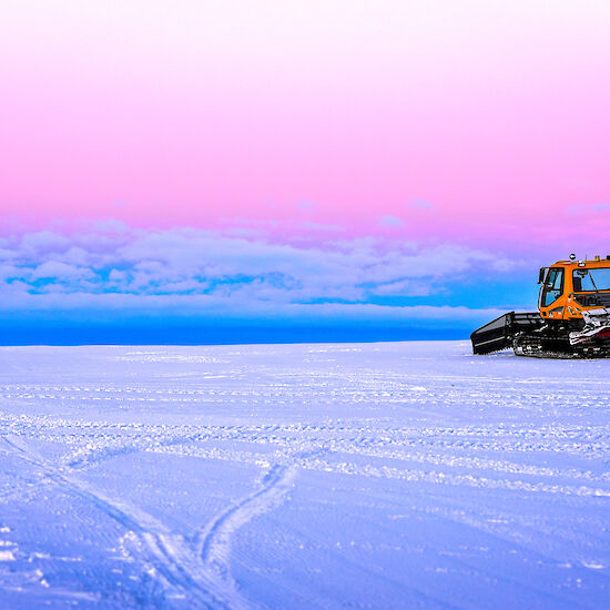 Casey ski landing area at dusk with a large tracked vehicle to the right