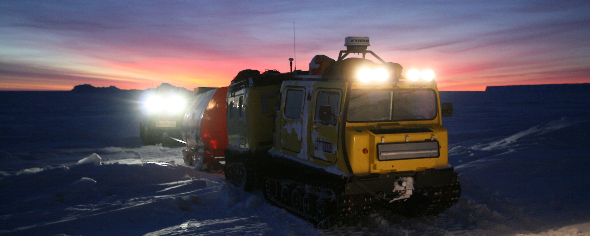 Mawson station Hagglund heading off in the morning twilight