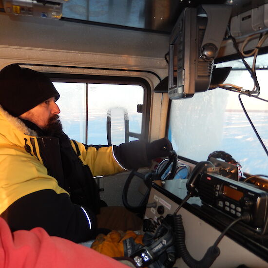 Expeditioner driving a hagglund, photo taken from inside the hagg