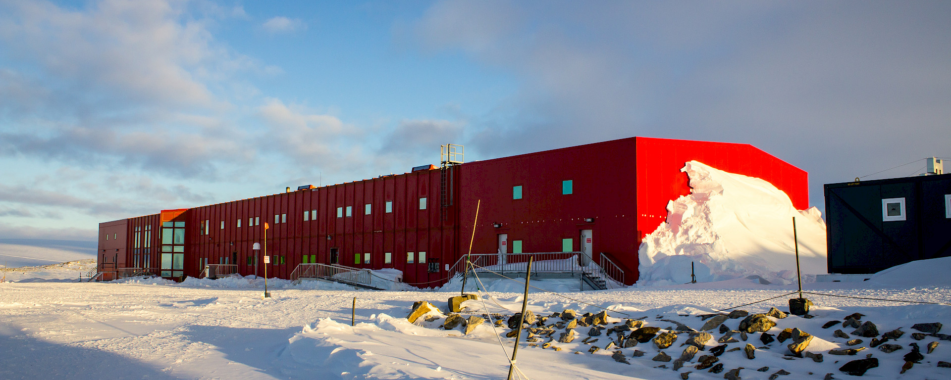 Large oblong bright red two story building