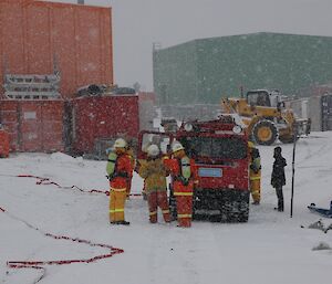 Expeditioners with Hägglunds vehicle in the snow