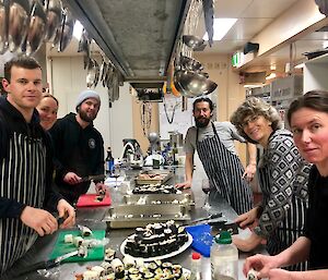 Expeditioners in the kitchen learning how to cook