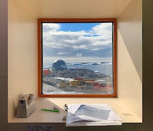 View of station buildings and coastline from inside looking out the window