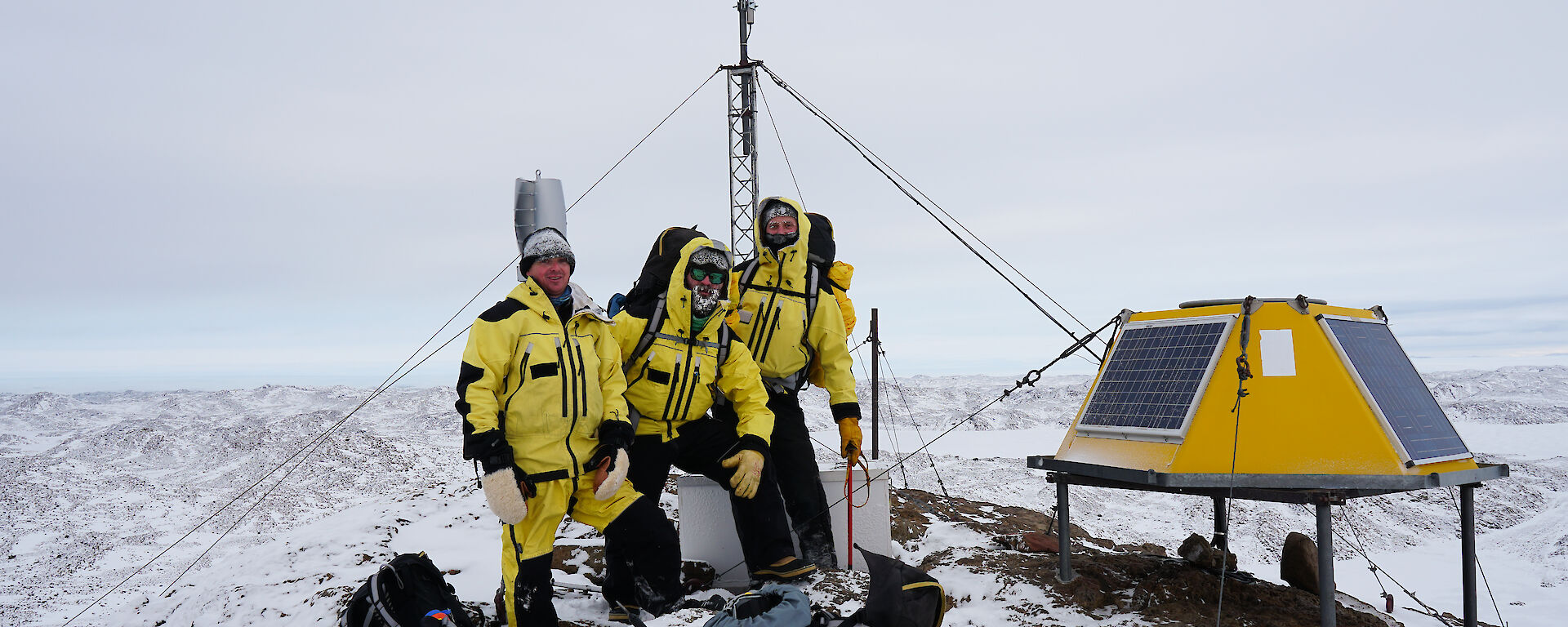 Group of expeditioners standing near VHF repeater