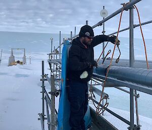 Plumber working on service piping in the snow