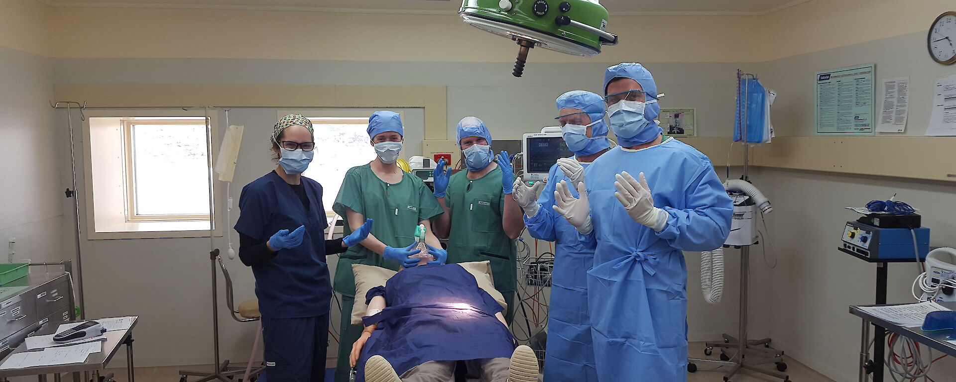 Group of medical assistants and doctor in a practice surgery scenario