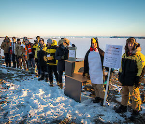 Expeditioners queue outdoors to cast a vote in the election