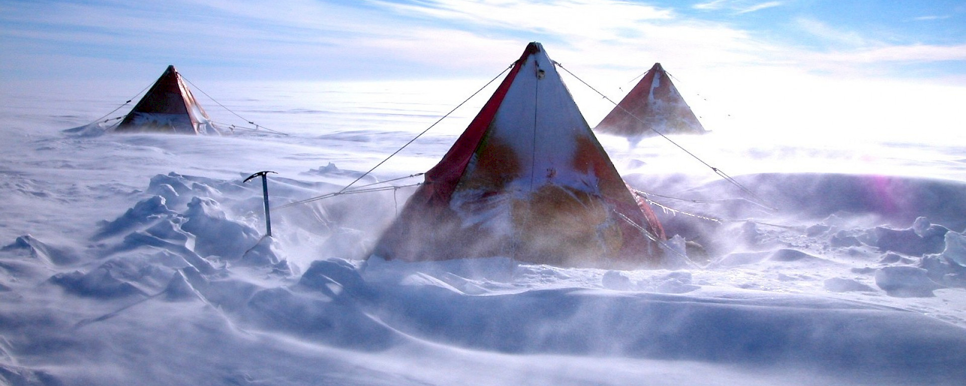 Snow blows around a tent.