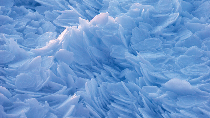 Small round particles of ice piled on top of each other