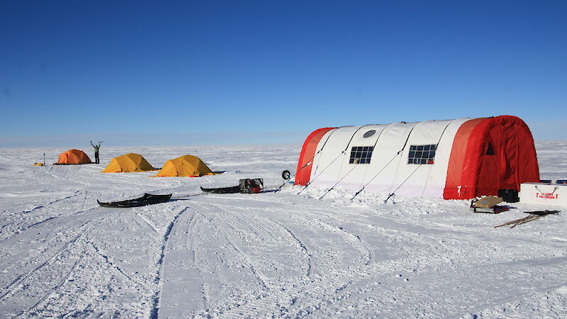 Tents in a snowy landscape.