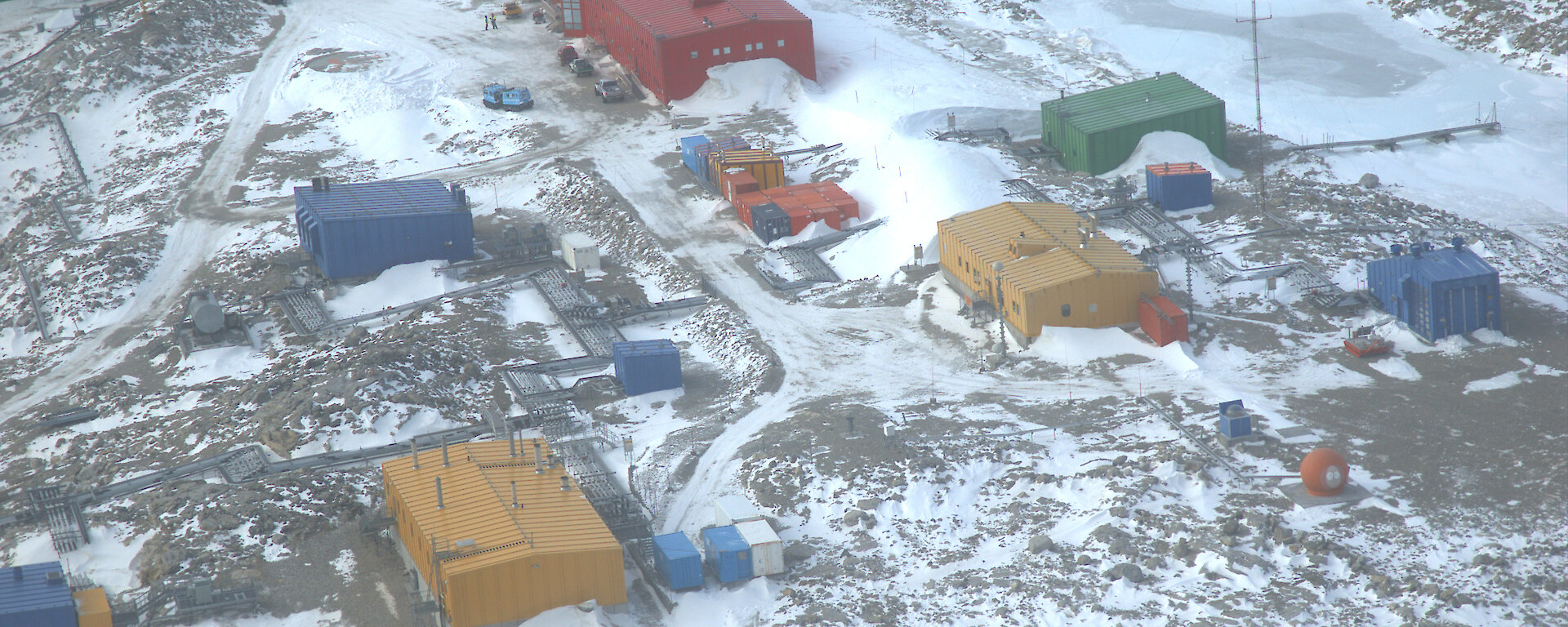 Aerial view of Casey station showing brightly coloured buildings in the snow