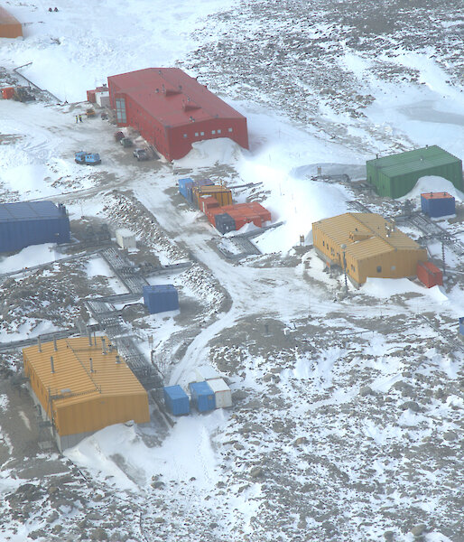 Aerial view of Casey station showing brightly coloured buildings in the snow