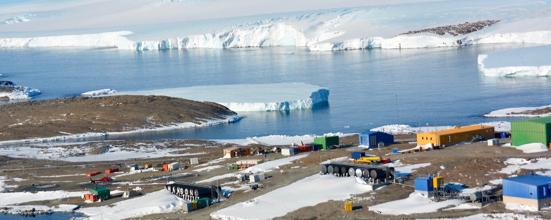 Aerial view of Mawson station and East Bay with ice sheet on clear bright day