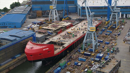Ship under construction floating in dry dock
