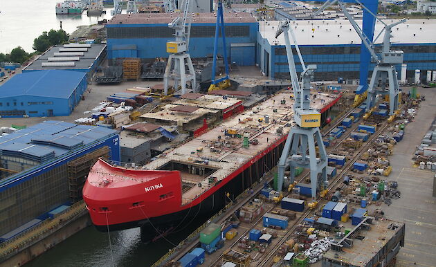 Ship under construction floating in dry dock