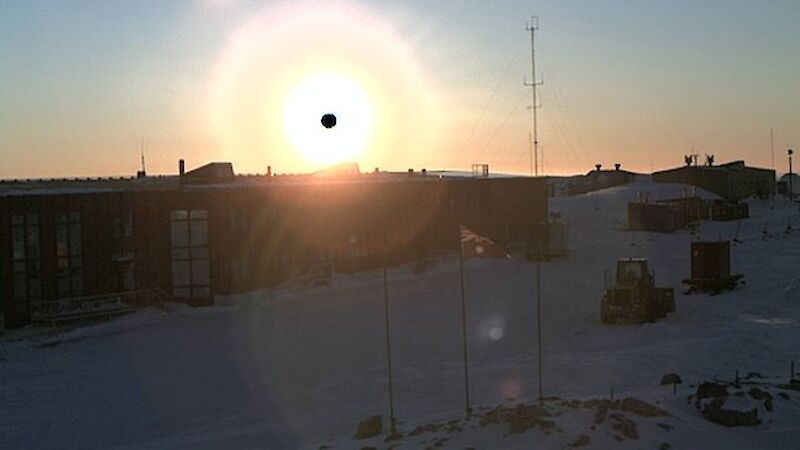 Black circle over sun above Casey Red Shed