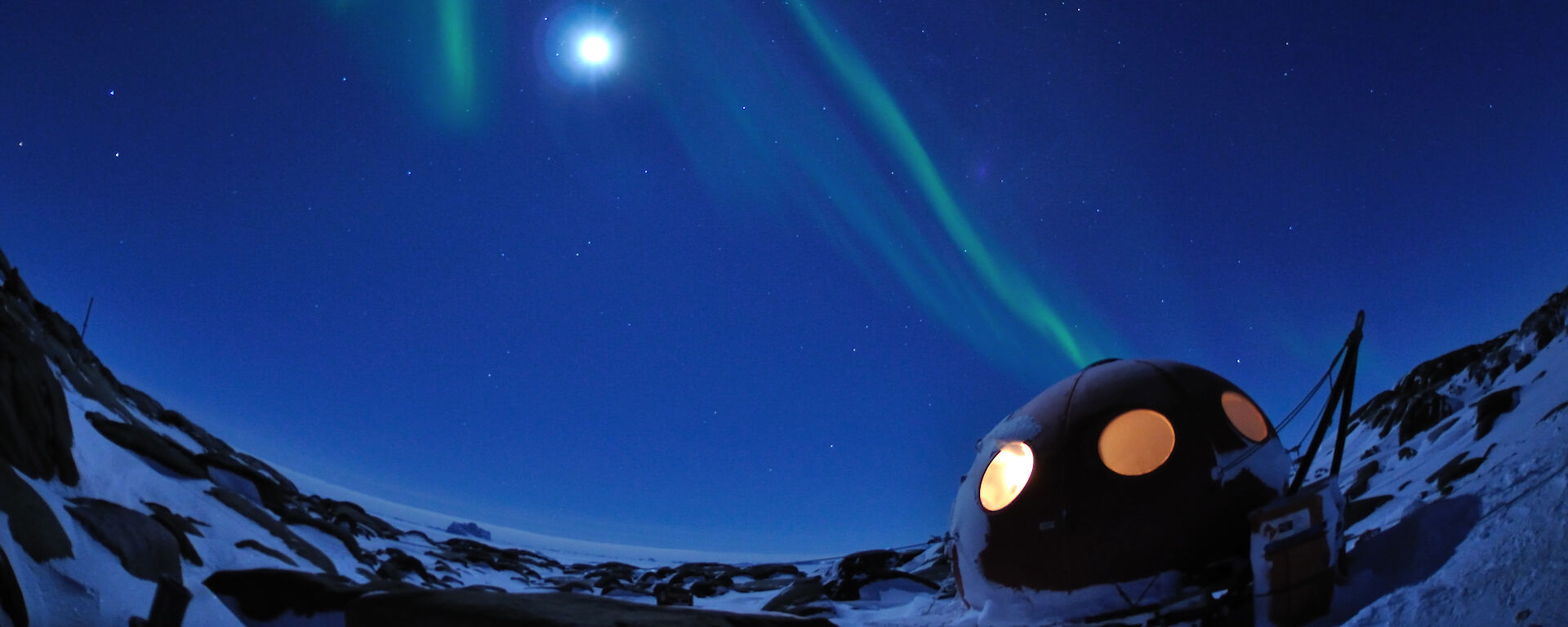 Aurora over apple-shaped field hut