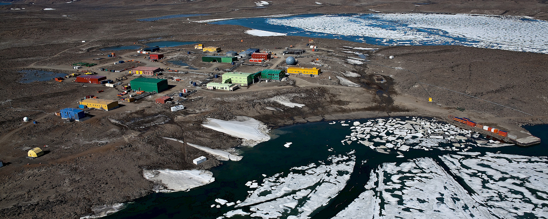 A collection of colourful buildings, viewed from the air.