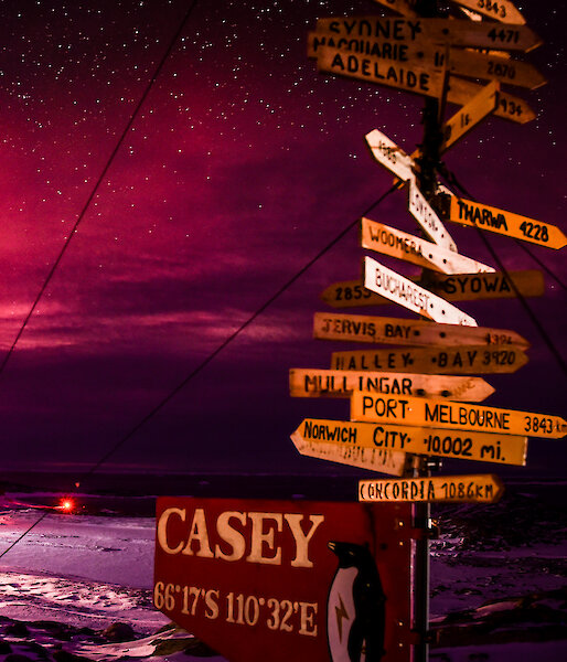 Panorama of the Aurora Australis in the red spectrum over Casey station on clear starry night
