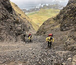 Paul Farrow (top) and Ben Woods scale a scree slop from Davis Point hut up to the plateau.